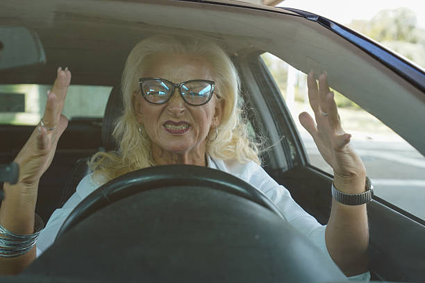istock Middle-aged woman stressed and arguing in traffic while driving a car 2241808046