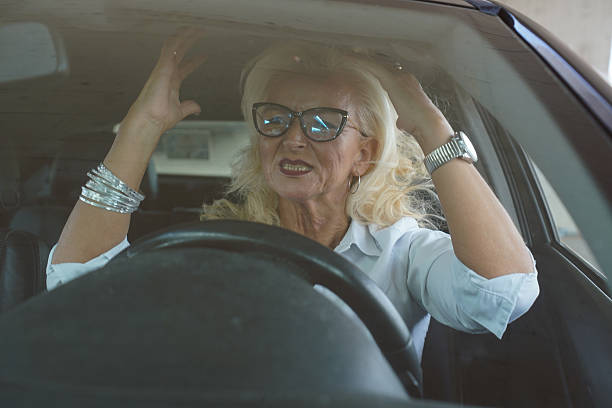 istock Middle-aged woman stressed and arguing in traffic while driving a car 2241808049
