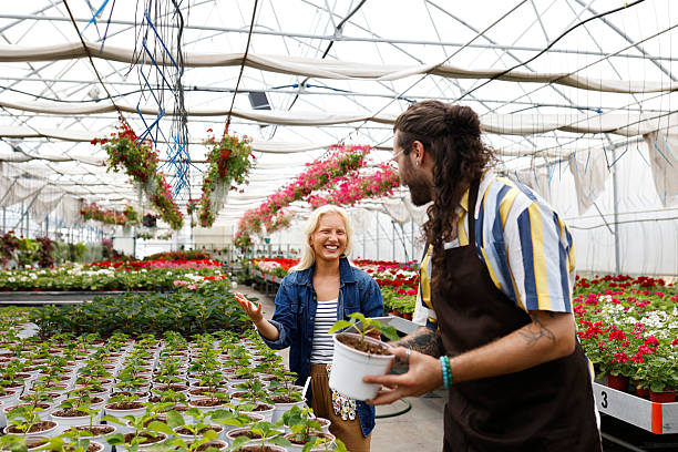 istock Couple Working Together in Flower Nursery 2241811472