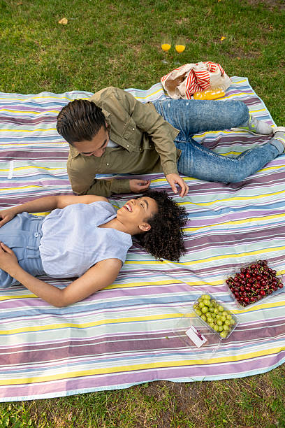 istock Interracial couple having fun during summer picnic in park 2241812294