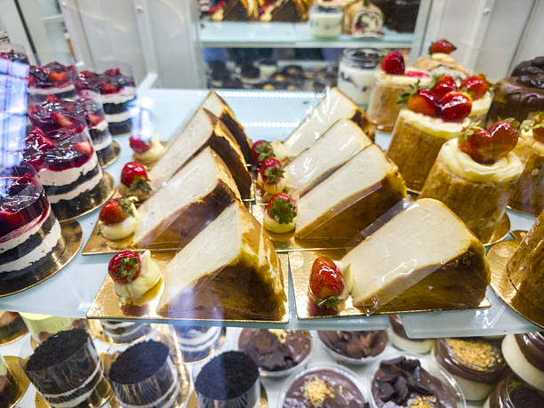 istock Different cakes with fresh fruits and berries in store window. Delightful array of colorful pastries and desserts displayed in a bakery. 2241813208
