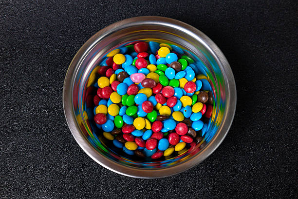 istock Colorful candy bowl filled with assorted chocolate candies in vibrant colors ready for sharing during a festive occasion 2241814876