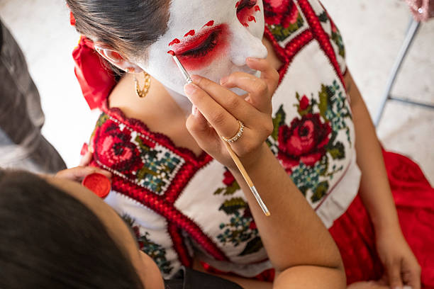 istock Makeup class demonstrating the process of applying catrina makeup, specially designed for one of the most iconic and traditional celebrations in Mexican culture: the Day of the Dead. 2241815759