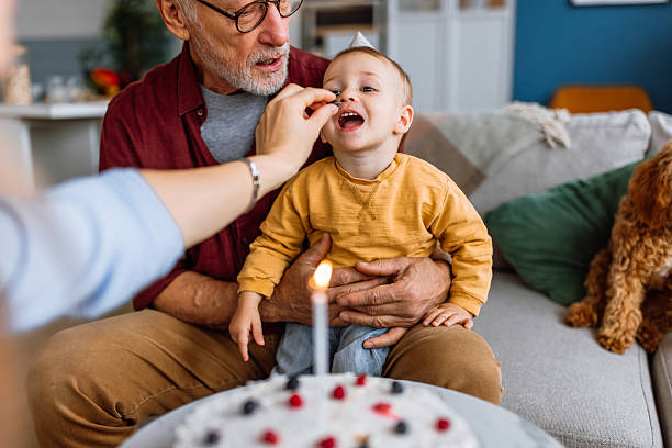 istock Birthday boy tasting birthday cake. 2241819329