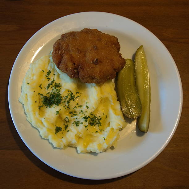 Rissole with mashed potatoes and pickled cucumber in Czech Republic, Europe