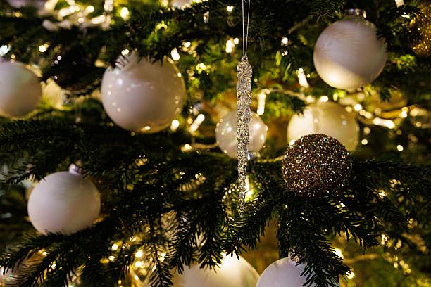 istock Beautifully decorated Christmas tree with white ornaments and sparkling lights during winter holiday season 2241823929