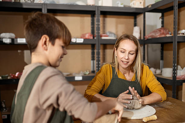 istock Mother and Son Joining Pottery Class in Art Studio 2241826080