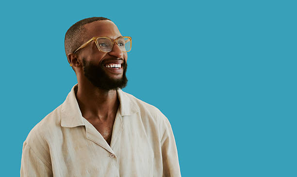 istock Smiling African American Man Wearing Glasses Against Solid Blue 2241828792