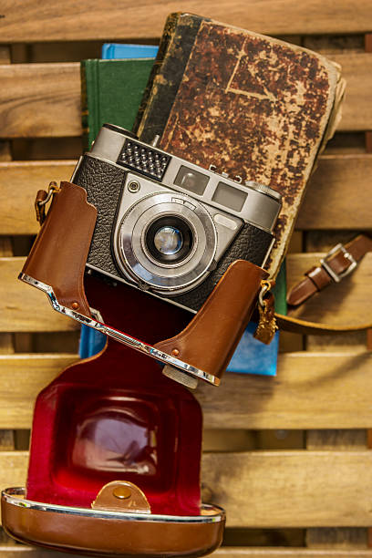 istock Vintage style still life with old camera with leather case on old books 2241831009