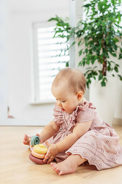 istock Baby girl stacking pastel toy rings. Development milestones 2241832385