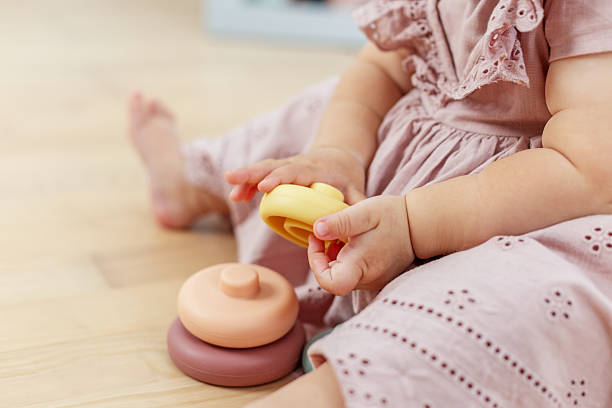 istock Baby girl playing with stacking toy rings 2241832387
