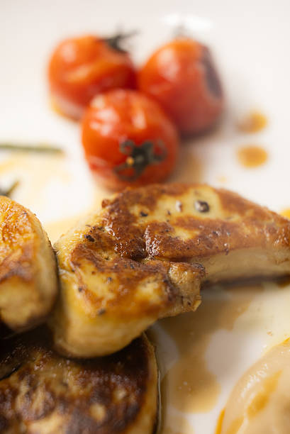 istock Elegant Gourmet Dish: Succulent Seared Foie Gras with Roasted Tomato and Thyme, Served with a Rich, Exclusive Specialty Sauce on a White Plate 2241833243