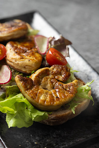 Exquisite Close-up of Gourmet Foie Gras on Toasted Bread, Elegantly Garnished with Fresh Herbs, Creating a Luxurious and Tempting Fine Dining Appetizer