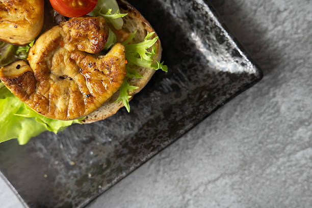 Exquisite Close-up of Gourmet Foie Gras on Toasted Bread, Elegantly Garnished with Fresh Herbs, Creating a Luxurious and Tempting Fine Dining Appetizer