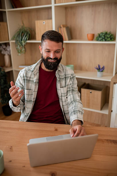 istock Excited man smiling at laptop 2241834637