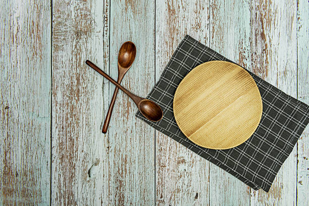 istock Some dark wooden spoons on a black cloth with white lines 2241839132