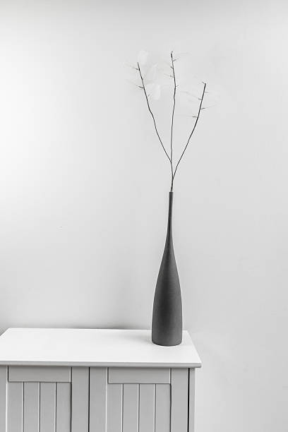 istock A small white wooden cabinet with a gray vase with artificial branches with subtle white leaves 2241839878