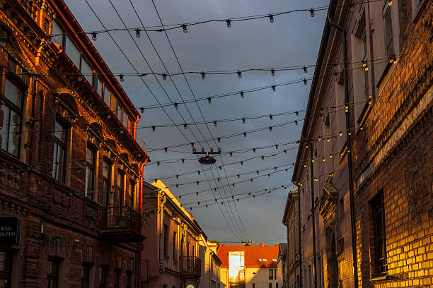 istock Warm evening sunlight on historic brick buildings with hanging lights 2241839965