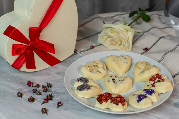 istock Heart-shaped white chocolates with assorted toppings and gift box 2241841151