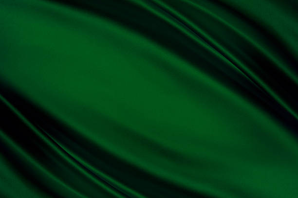 istock Emerald green silk fabric with glossy folds, copy space 2241845313