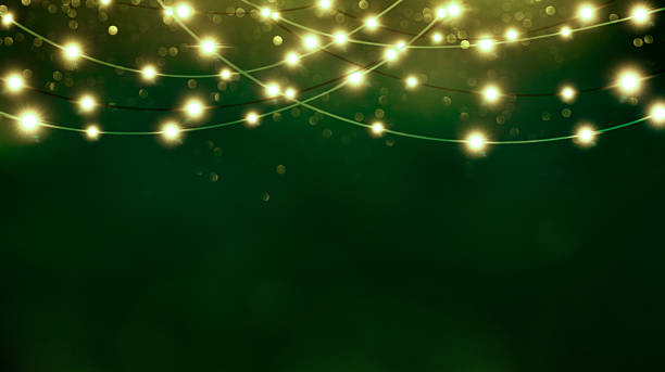 istock Warm string lights on green festive bokeh background with copy space 2241845320