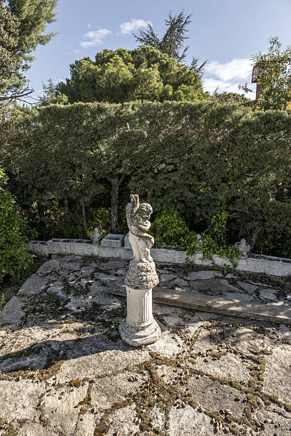 istock Plot of a farm with perimeter hedges, decorative stone figures and stone floors 2241849010