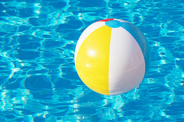 istock Colorful inflatable ball floating in swimming pool 2241858730