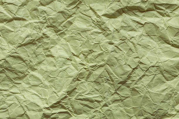 Crumpled Green Paper Texture with Wrinkled Surface Close-Up