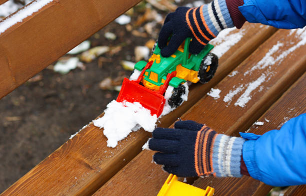 A child plays with the first snow.