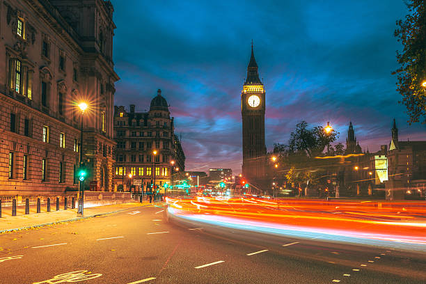 Detailed view of the lit clock faces of Big Ben and Palace of Westminster at twilight.