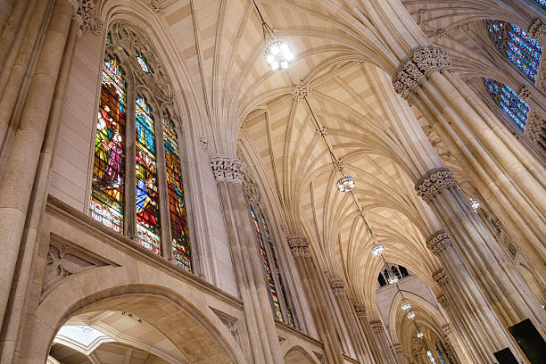 istock Stained Glass and Arched Vaults Inside Gothic Cathedral 2241880617