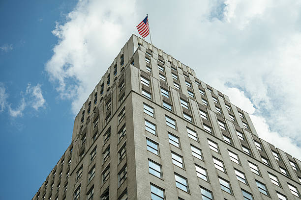 istock Corner View of Office Building With American Flag 2241887582