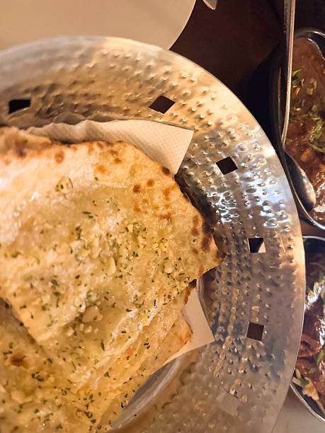 istock Slices of garlic cheese naan on a silver plate 2241898979