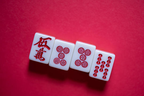 Mahjong tiles lined up on a red background