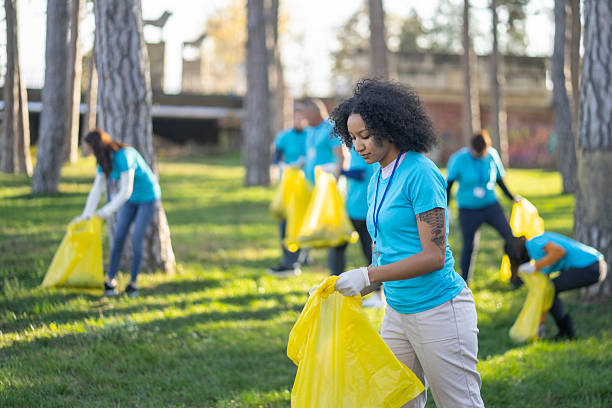 istock Volunteers picking up trash in a sunny park 2241900429