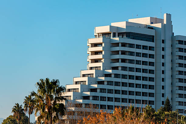 Tel Aviv-Yafo, Israel - June 6, 2018: Facade view of the Hilton Tel Aviv Hotel at the Tel Aviv beach. The building reflects the mid-century modern, modernist style.