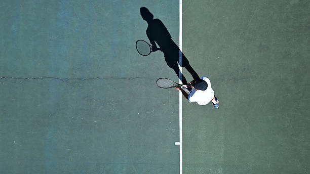 istock Tennis Player Practicing on Hardcourt from Above 2241900661