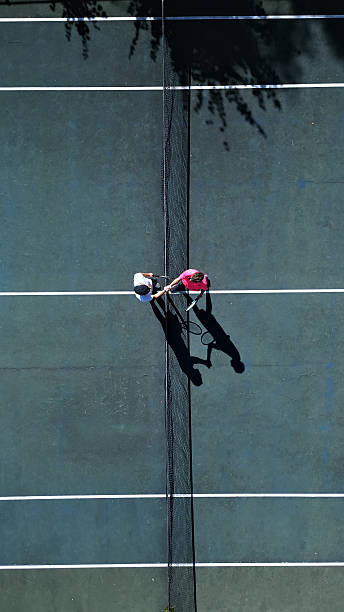 istock Two Tennis Players Practicing Doubles Positioning on Hardcourt 2241900665