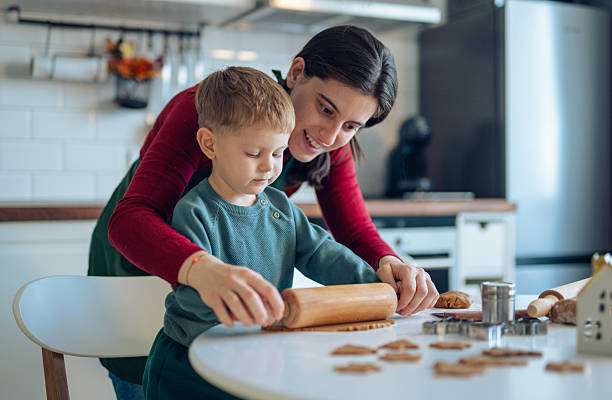 istock Little boy and his mom making gingerbread cookies. 2241900820