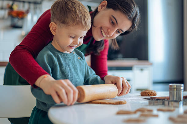 istock Little boy and his mom making gingerbread cookies. 2241900825