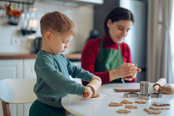 istock Little boy and his mom making gingerbread cookies. 2241900827