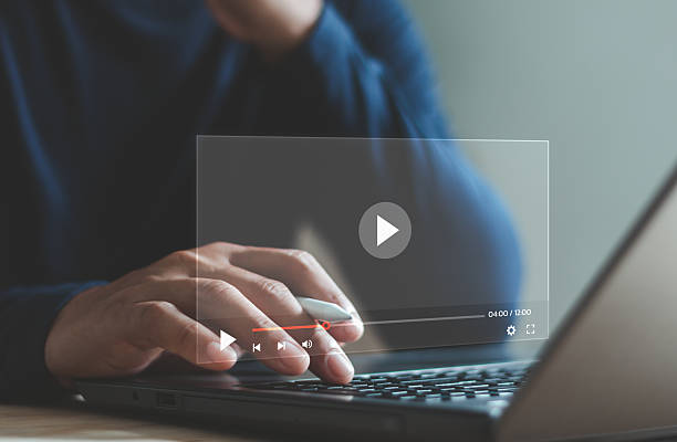 istock Businessman using laptop to play online video, showing digital media streaming interface and modern technology for video content, online learning or entertainment platform for marketing and education. 2241901449