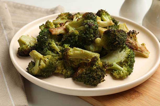 istock Tasty fried broccoli on white table, closeup 2241903090