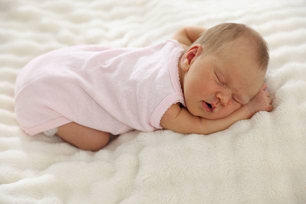 istock Cute newborn baby sleeping on bed indoors 2241903304