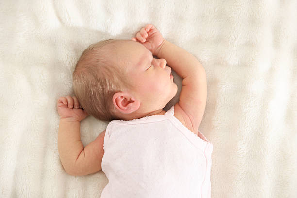 istock Cute newborn baby sleeping on bed, top view 2241903324
