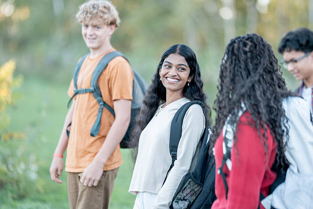 istock Smiling Diverse Group Of Students With Backpacks Walking Outdoors On A Sunny Day 2241903673