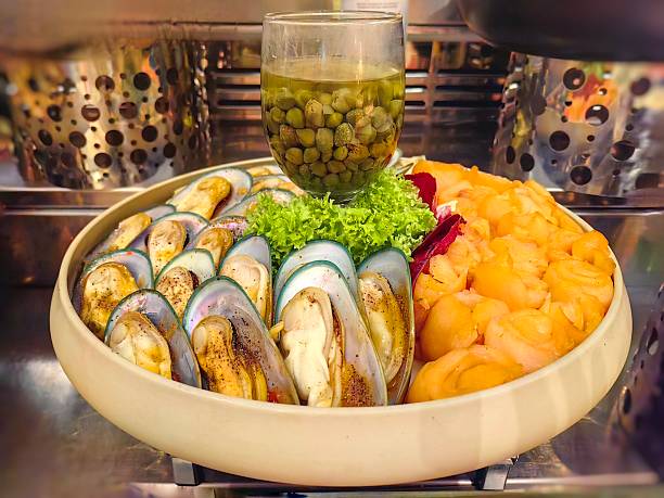 Fresh smoked salmon with boiled clams salad served ith dresing.