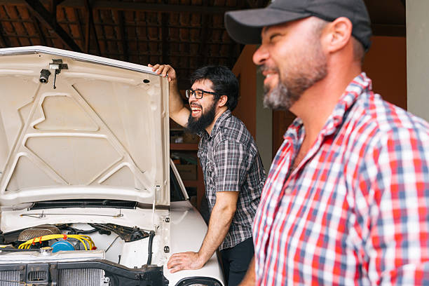 istock Owners sharing a proud moment with their restored muscle car 2241915221