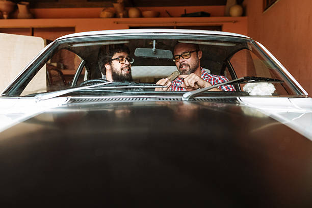 Car enthusiasts inspecting car interior together