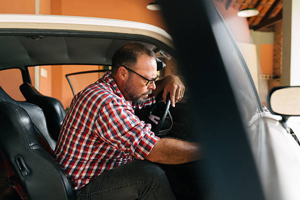 istock Man inspecting interior of classic car 2241915267